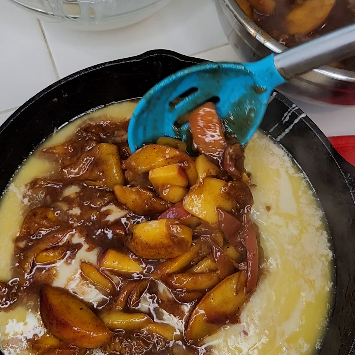 spoon peaches over batter