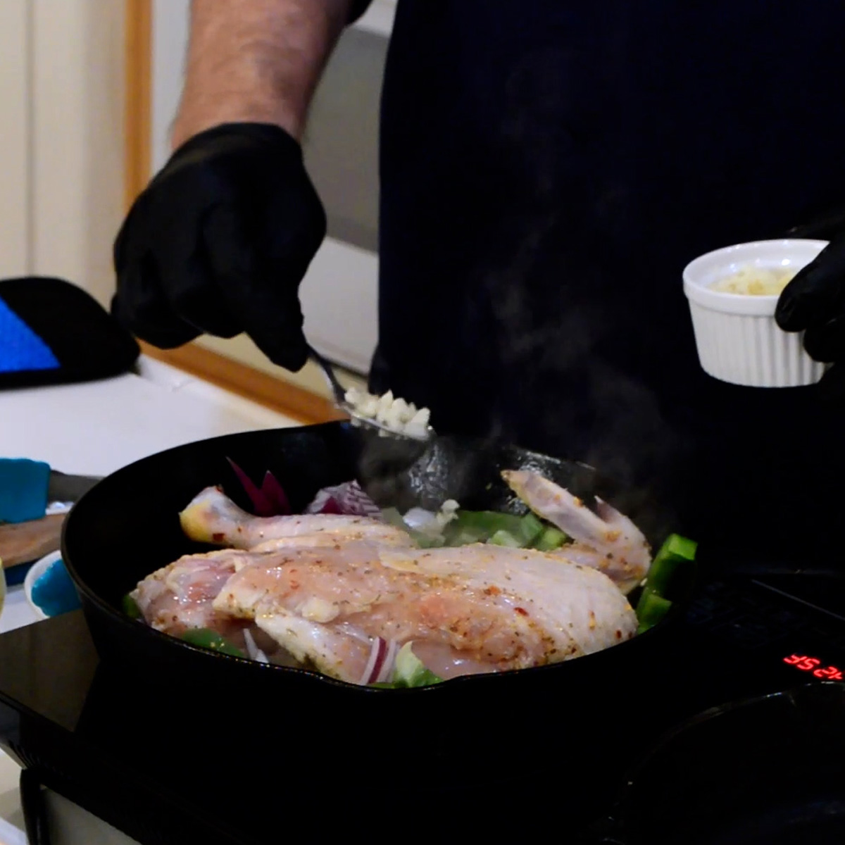 brick chicken add garlic peppers and onions
